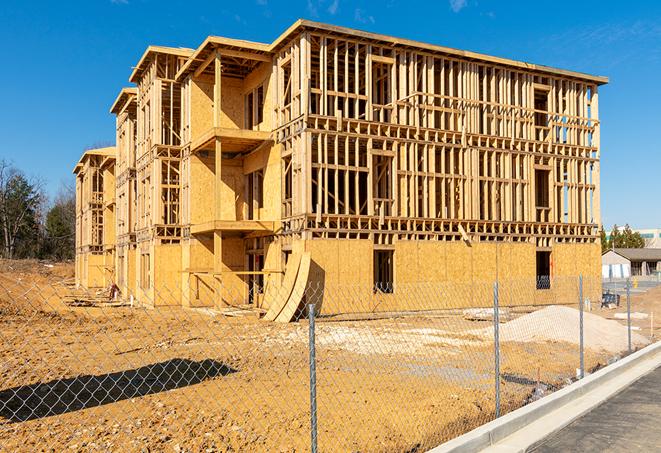 a close-up of temporary chain link fences enclosing a job site, signaling progress in the project's development in Newport, NC